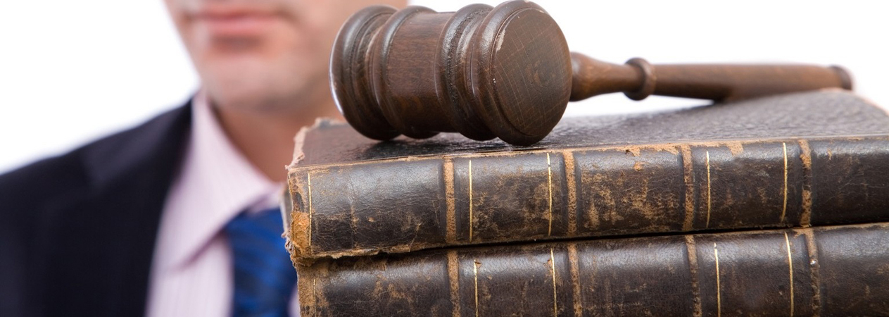 legal concept with businessman holding gavel and law books